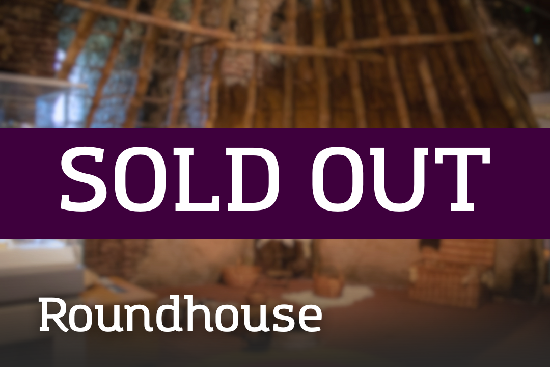 A reconstructed roundhouse interior with a timber frame and woven materials, overlaid with a “SOLD OUT” banner and the label “Roundhouse.”