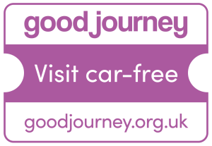 A purple rectangular badge with rounded corners showing the Good Journey logo. The top section reads ‘good journey’ in bold lowercase text. The middle section says ‘Visit car‑free,’ and the bottom section displays the website address ‘goodjourney.org.uk.’